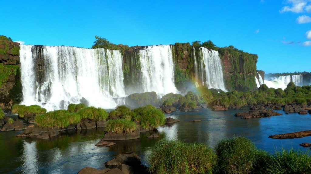 Big and wide waterfalls with small rainbow
